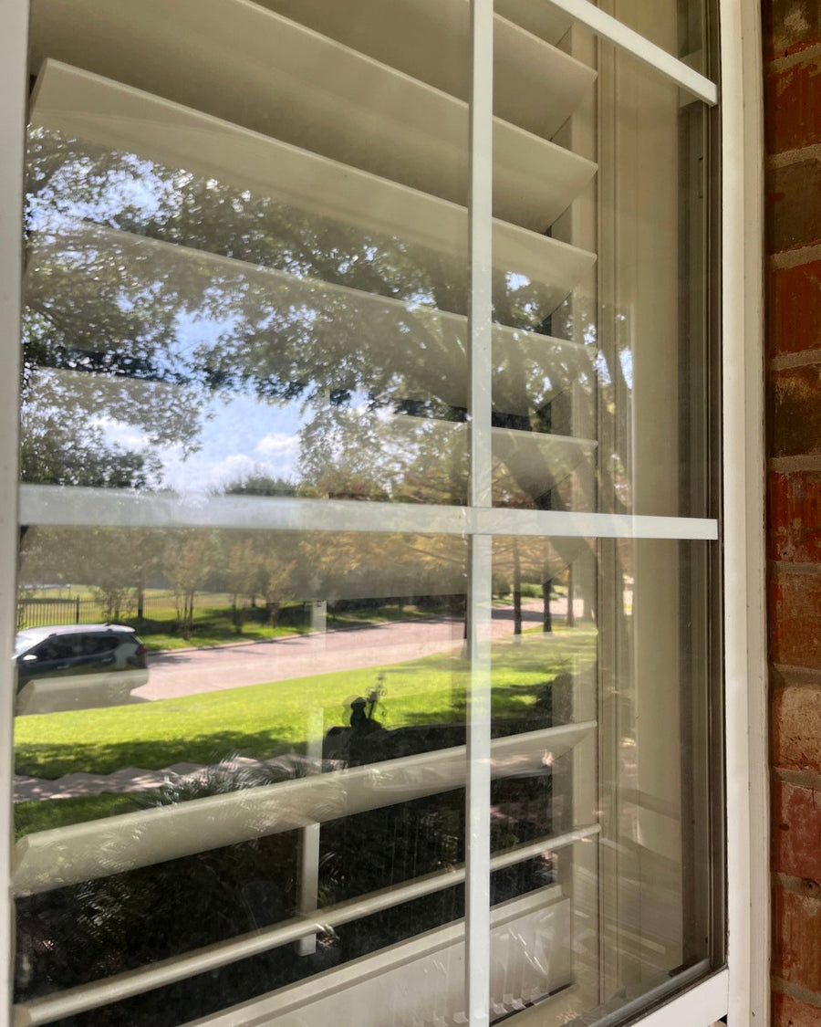 Clean windows on a Waco home